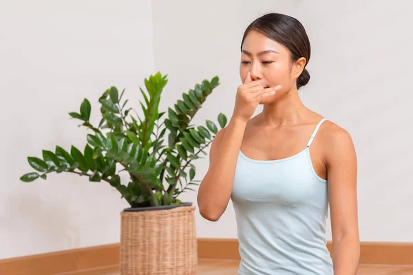 Asian woman doing breathing exercise before practice yoga.Healthy female inhaling and exhaling to deep breath exercise for control and balance life with yoga meditation decrease stress, relax her mind