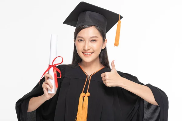 漂亮迷人的亚洲女人 戴着帽子 头戴礼服 面带微笑毕业 手握证书 感到无比自豪和幸福 与白人背景隔离 教育成功理念 — 图库照片