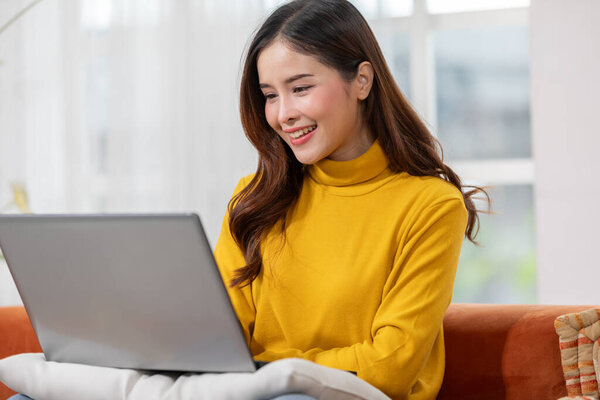 Beautiful Asian Young Woman Wear Casual Sit Couch Using Computer Royalty Free Stock Photos