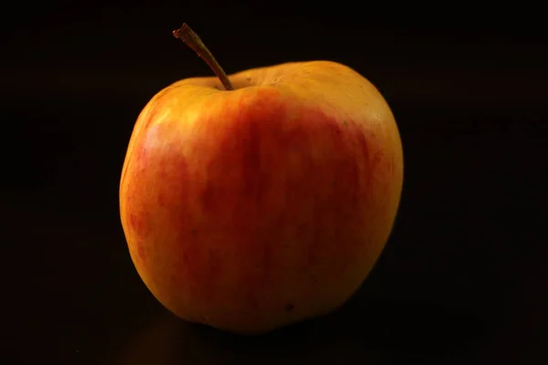 An apple with a black background
