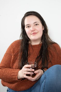portrait of a young woman with a glass of tea