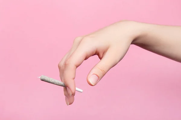 Woman Hand Holds Joint Medical Marijuana Her Fingers Pink Background — Stock Photo, Image