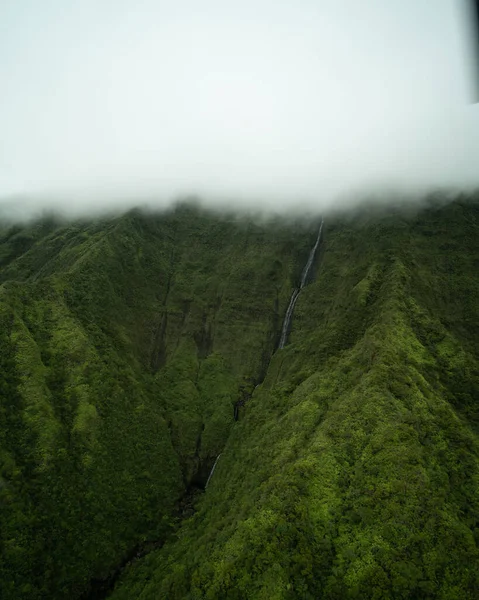 Aerial of Green Cliffs of Na Pali Coast on Kauai, Hawaii. High quality photo. Lush green giant cliffs shot from a helicopter tour along Kauai's Northeast coast.
