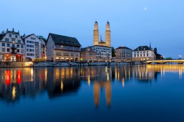 Historic architecture at the Limmat riverbank in Zurich at night clipart