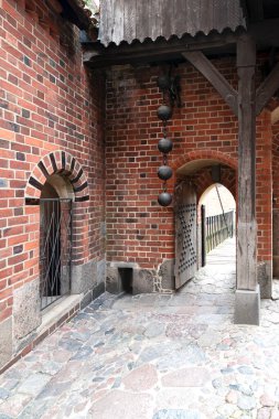 Drawbridge pulling mechanism as part of a bridge leading to a medieval castle clipart