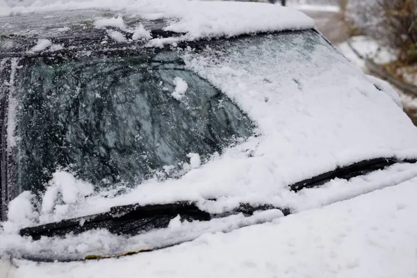 Kar yüzünden yarı temizlenmiş araba ön camı