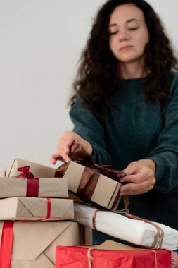 Woman preparing Christmas gifts at home clipart