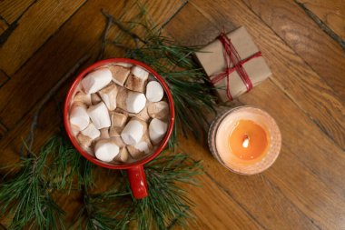 Holiday cocoa with marshmallows and pine tree twigs and gifts clipart