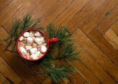 Cozy cocoa with marshmallows and pine branches clipart