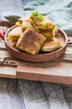 Indonesian street food: Martabak telur is a fried wrap filled with eggs, minced meat, and vegetables.