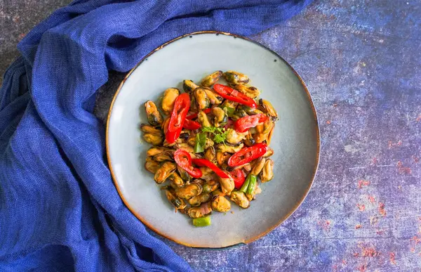 stock image Tumis Kerang Kupas, Stir stir-fried clams cooked with a slice of red chili, onion, garlic, and other spices.