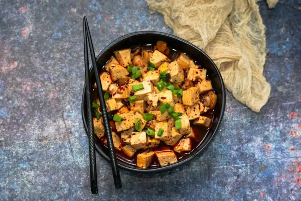Siyah kasede mantarlı vejetaryen Mapo tofusu. Geleneksel Çin yemeği.