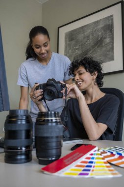 Female photographers working in creative office