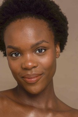 Studio close up portrait of smiling woman