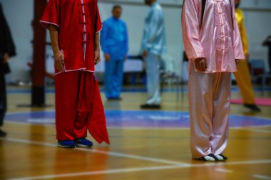 Wing Chun kung fu öğrencileri geleneksel Çin üniformaları giyip stadyumda antrenman yapıyorlar. Savunma sporları.