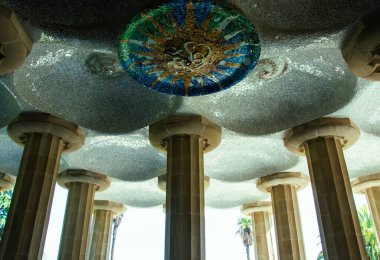 İspanya, Barcelona Park Gell 'deki Hypostyle Salonu' nun mimari detayları. Antoni Gaud 'un tasarladığı renkli mozaik fayanslarla dekore edilmiş tavanı destekleyen devasa taş sütunlar..
