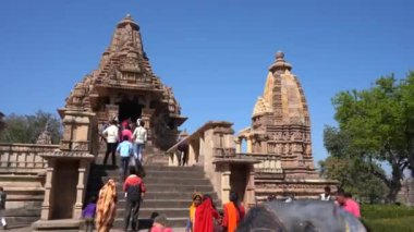 KHAJURAHO, MADHYA PRADESH, INDIA, 01 Mart 2022: Erotik mimarisi nedeniyle Khajuraho tapınağına turistik bir ziyaret, düzenli olarak pek çok ziyaretçi çekmek, UNESCO Dünya Mirası Sitesi.