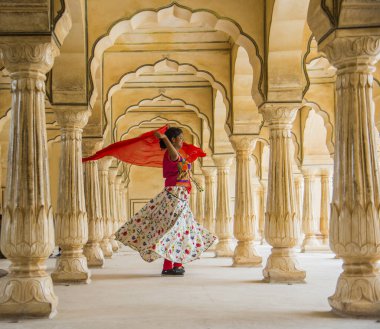Amber Fort, Jaipur, Rajasthan, Hindistan 'daki Sütunlar Odasında dans eden genç bayan turist UNESCO Dünya Mirası Bölgesi.