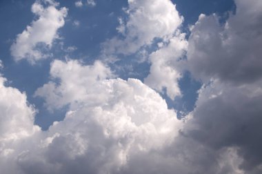 Doğal gün ışığı ve mavi gökyüzünde süzülen beyaz bulutlar