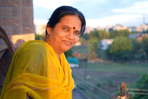Portrait of happy Indian woman at her home