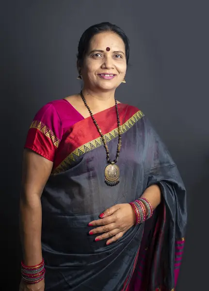 Portrait of a happy Indian woman in saree.