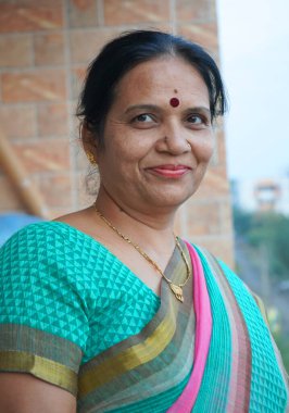 Gülümseyen olgun Hintli kadın portresi.