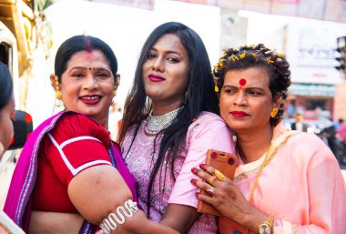 AMRAVATI, MAHARASHTRA, INDIA, 09 JANUARY 2023 : Portrait of transgender or hijra on the street during religious festival, They are social category in the Indian society who recognized as third gender. clipart