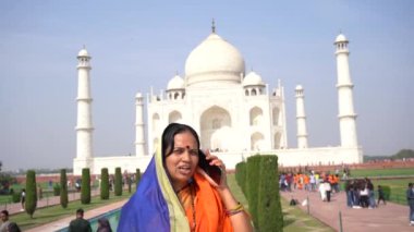 Hindistan 'ın Agra kentindeki UNESCO Dünya Mirası sitesi Taj Mahal' in önünde cep telefonundan konuşan bir kadın..
