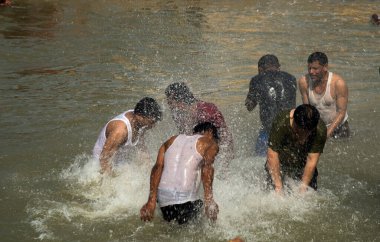 NASHIK, INDIA  29 AUGUST 2015 : Devotees take a holy bath at the in the river during the Simhastha Kumbh Mela. clipart