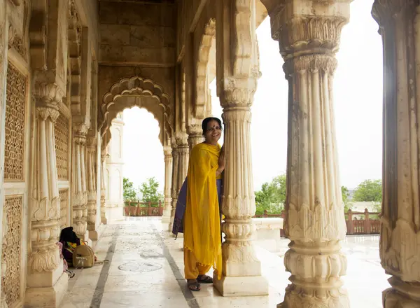 Kemerler ve Sütunlar arasında duran Hintli kadın.