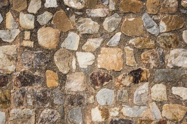 Antik taş duvarın arka planı, eski kale taşı duvar dokusu, taş yüzeylerin deseni..