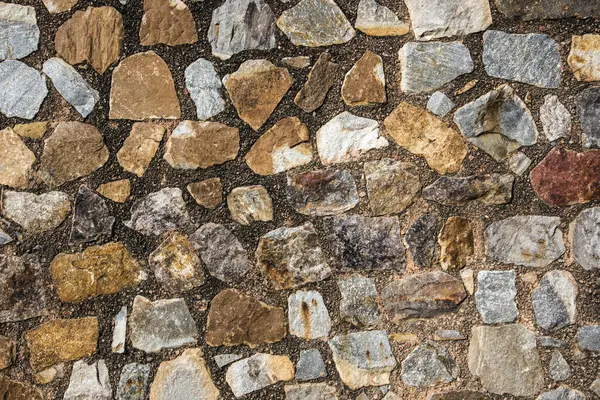 Antik taş duvarın arka planı, eski kale taşı duvar dokusu, taş yüzeylerin deseni..