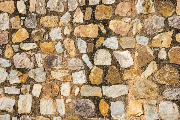 Antik taş duvarın arka planı, eski kale taşı duvar dokusu, taş yüzeylerin deseni..