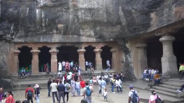 MUMBAI, MAHARASHTRA, INDIA, 9 Aralık 2024: UNESCO Dünya Mirası Sitesi, Fil Mağaraları 'nın mimarisi ve heykeline bakan turist.