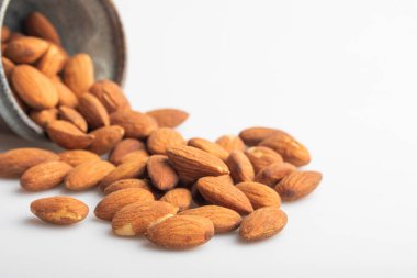 Beyaz bardakta tuzlanmış badem. Boşluğu kopyala.