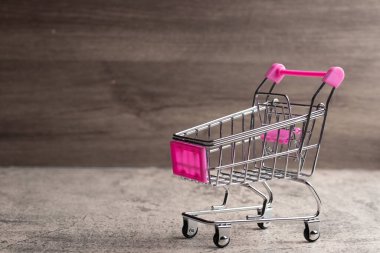 Shopping trolley on gray background with some copy space