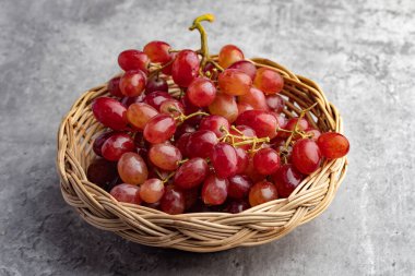 fresh red grapes on a gray background
