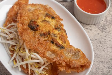 Fried mussels in crispy batter in a white plate