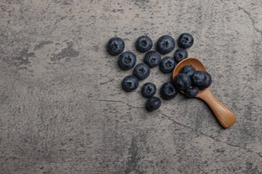 Fresh blueberries on gray background. Copy space.