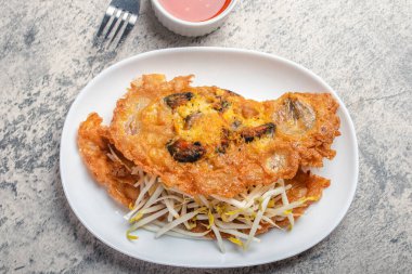 Fried mussels in crispy batter in a white plate