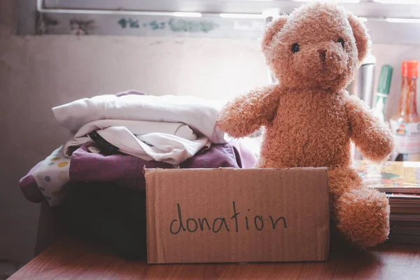 Clothes, books, teddy bears for donations. Social donation concept.