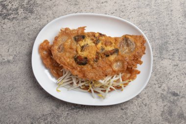 Fried mussels in crispy batter in a white plate
