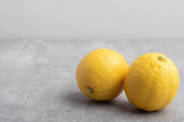 yellow lemons on a gray background