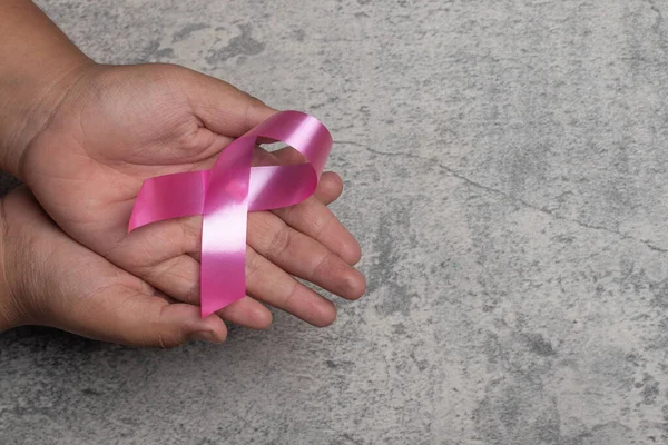Pink Ribbon Laying Hand Gray Background Breast Cancer Treatment Concept — Fotografia de Stock