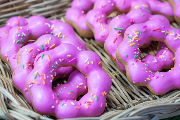 Sweet pink glazed donuts in a basket