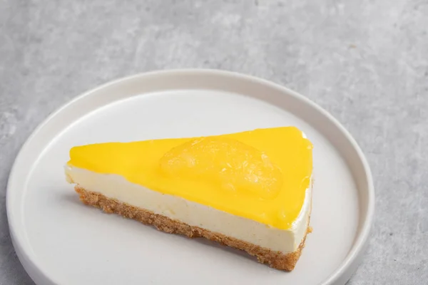 ホワイトプレート上の三角レモンチーズケーキ — ストック写真