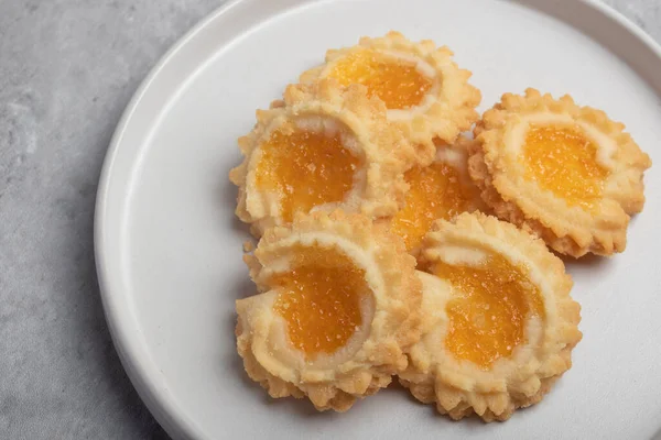 Orange cookies on a white plate
