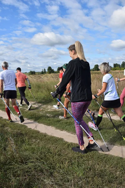 stock image Nordic walking athletes of different ages and genders compete in nature as a group