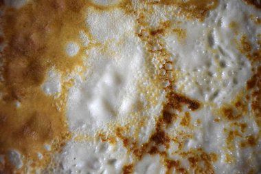Texture of delicious fried pancake close-up on whole background