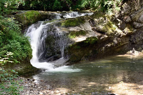 夏の公園の岩の近くの小さな川の滝 周辺環境の自然背景 — ストック写真